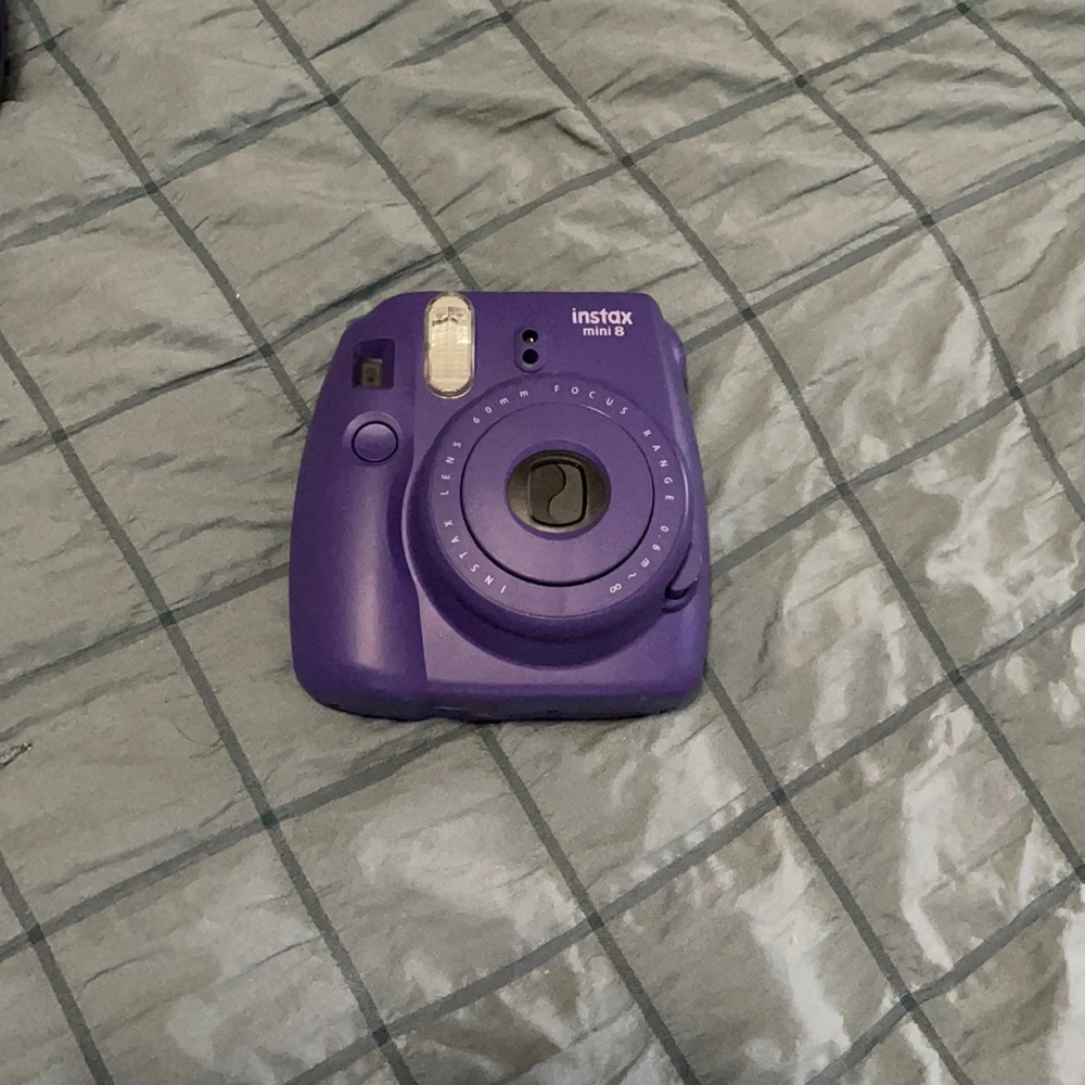 A purple Polaroid camera with purple case